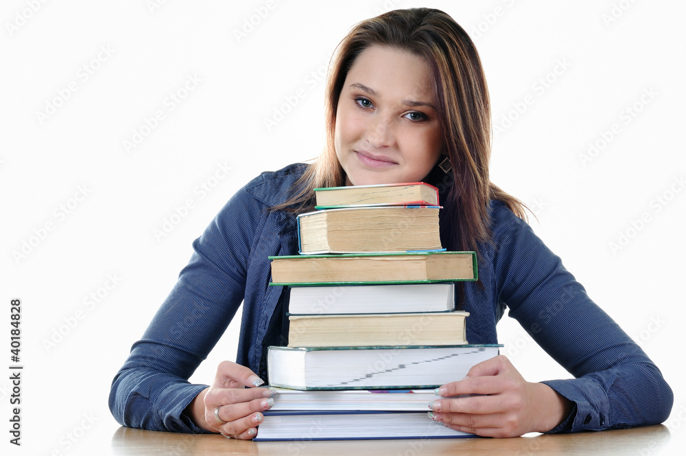 Nice student with books sitting at the table Nice student with books sitting at the table