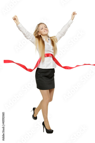 Full lengthof businesswoman crossing finishing line