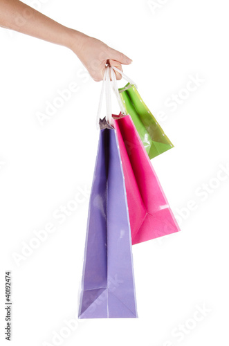 bright gift bags in hand isolated on white