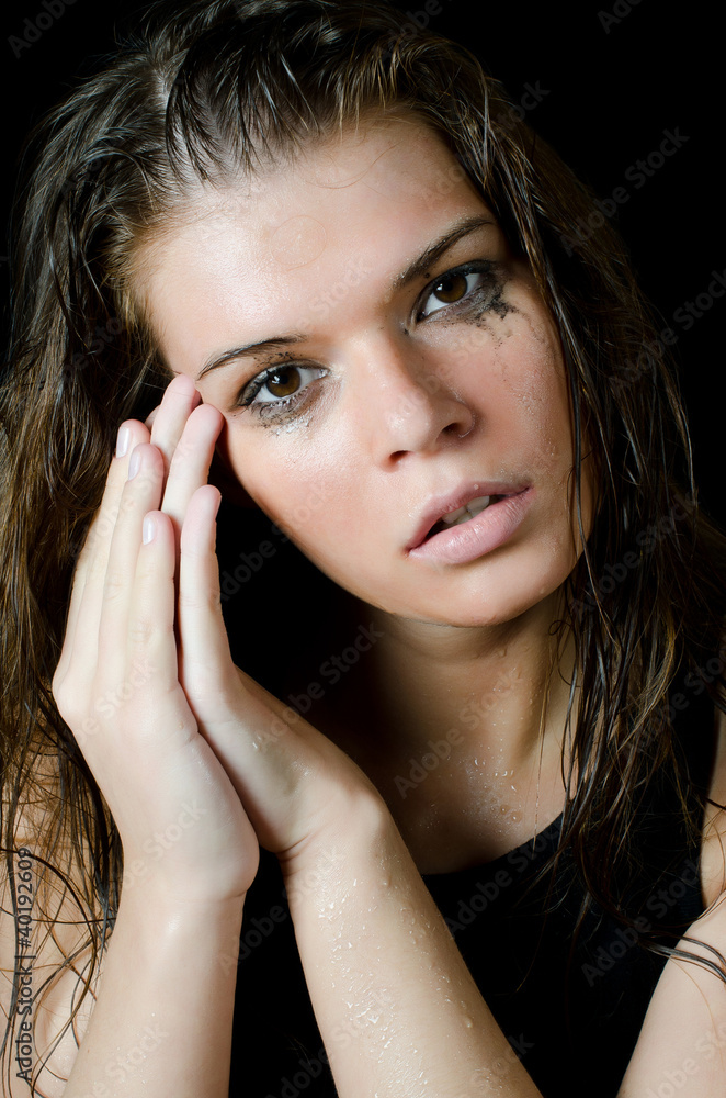 The wet girl with the spread cosmetics on the black The wet girl with the spread cosmetics on the black