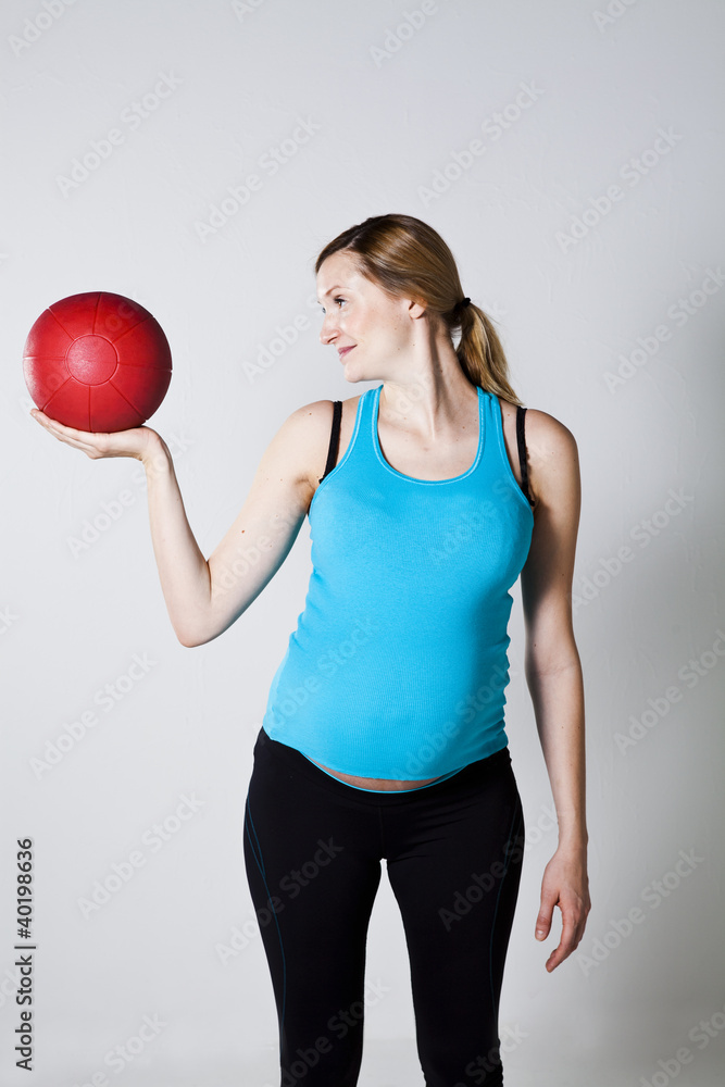 Pregnant woman exercising with exercise ball Pregnant woman exercising with exercise ball