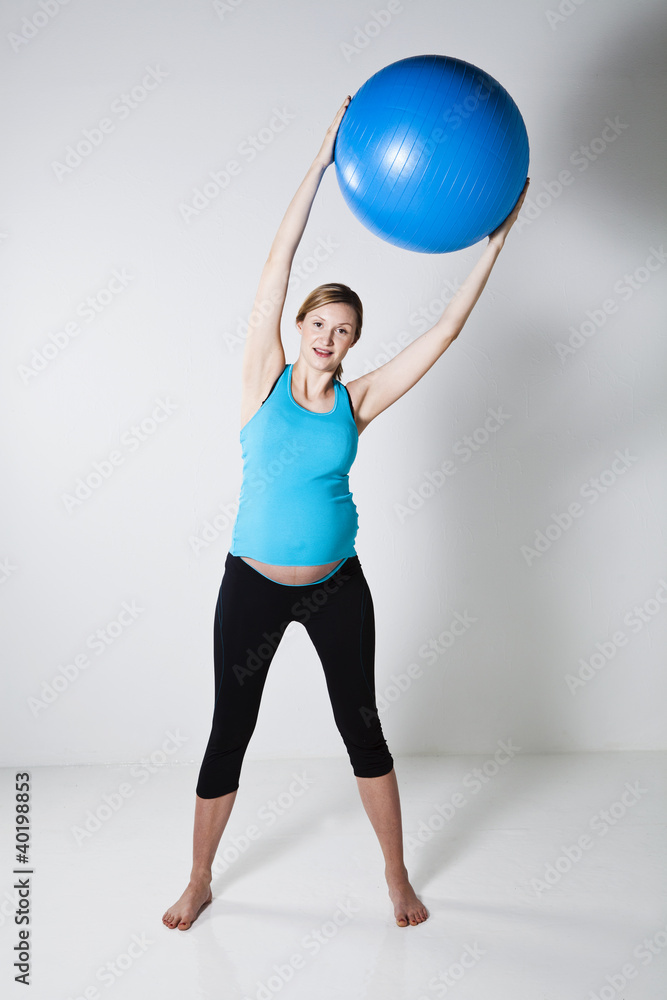 Pregnant woman exercising with fitness ball Pregnant woman exercising with fitness ball