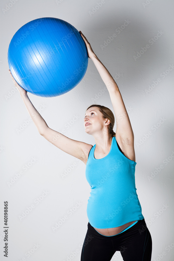 Pregnant woman exercising with fitness ball Pregnant woman exercising with fitness ball