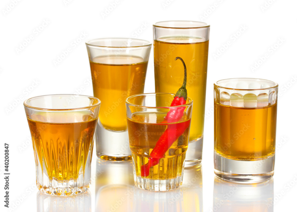 glasses of pepper vodka and red chili pepper isolated on white glasses of pepper vodka and red chili pepper isolated on white