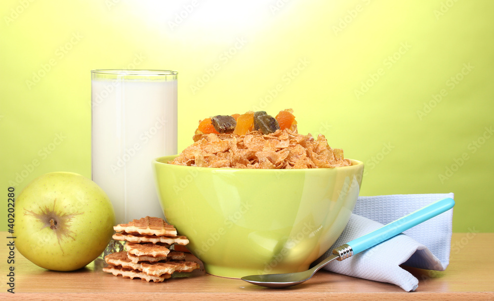tasty cornflakes in green bowl, apple and glass of milk tasty cornflakes in green bowl, apple and glass of milk