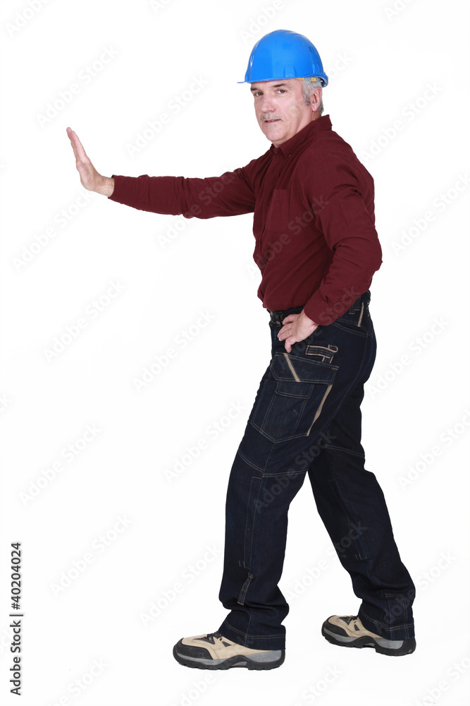 Workman pushing an invisible wall Workman pushing an invisible wall