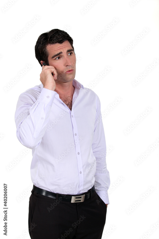 Concerned businessman taking phone call Concerned businessman taking phone call
