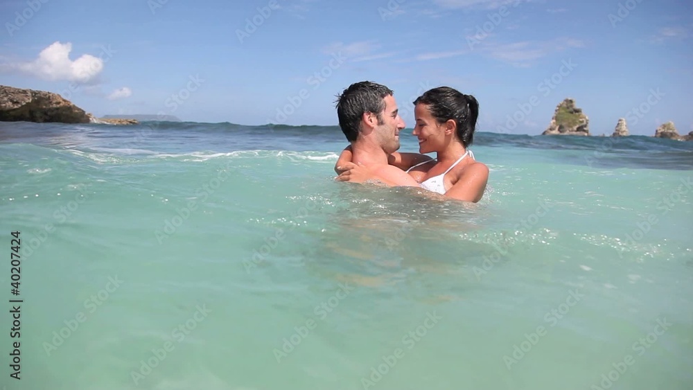 Cheerful couple swimming in the ocean Cheerful couple swimming in the ocean