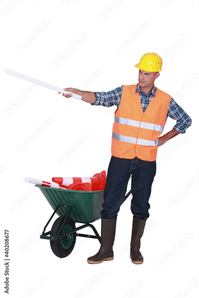 Foreman with plans and a barrow of traffic cones Foreman with plans and a barrow of traffic cones