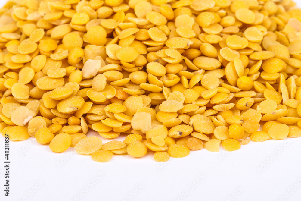 Yellow lentils isolated on white background.Macro shot Yellow lentils isolated on white background.Macro shot