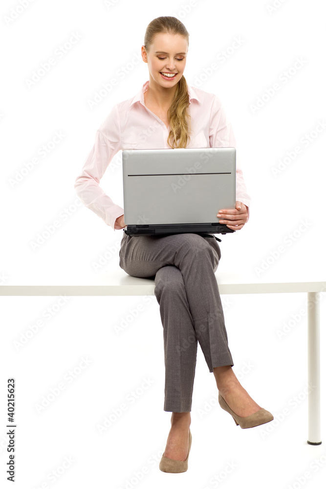 Woman sitting on table with laptop Woman sitting on table with laptop