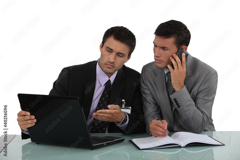 Businessman working out a problem on a laptop Businessman working out a problem on a laptop