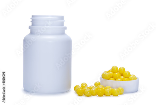 yellow pills and a plastic bottle