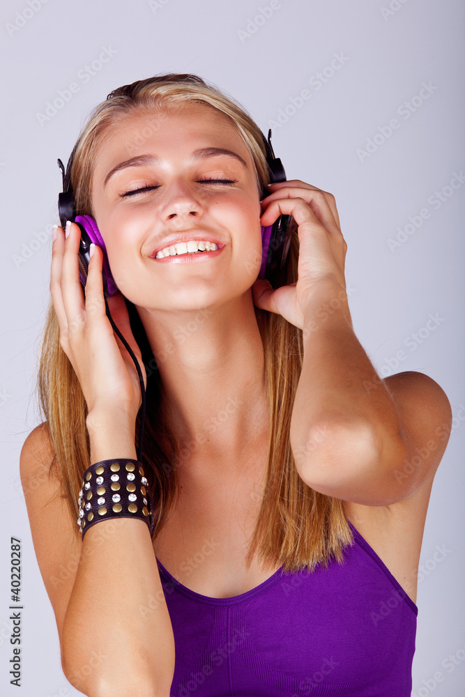 Fototapeta premium young woman listening to music