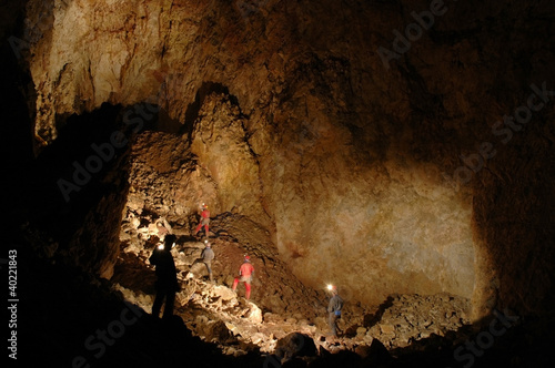 Fotografija Monumental cave hall with cavers exploring it
