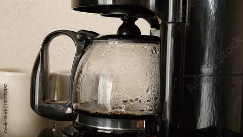 Close-up of coffee brewing in coffee maker photo