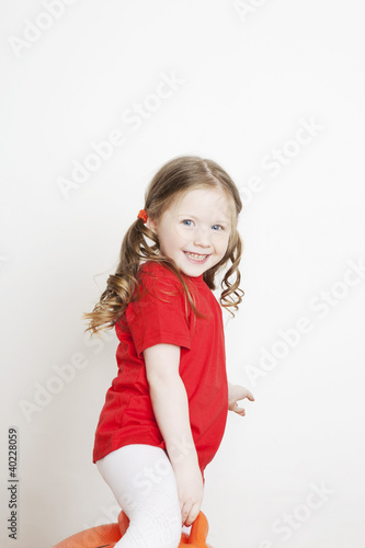 Portrait of a beautiful little girl playing in the studio