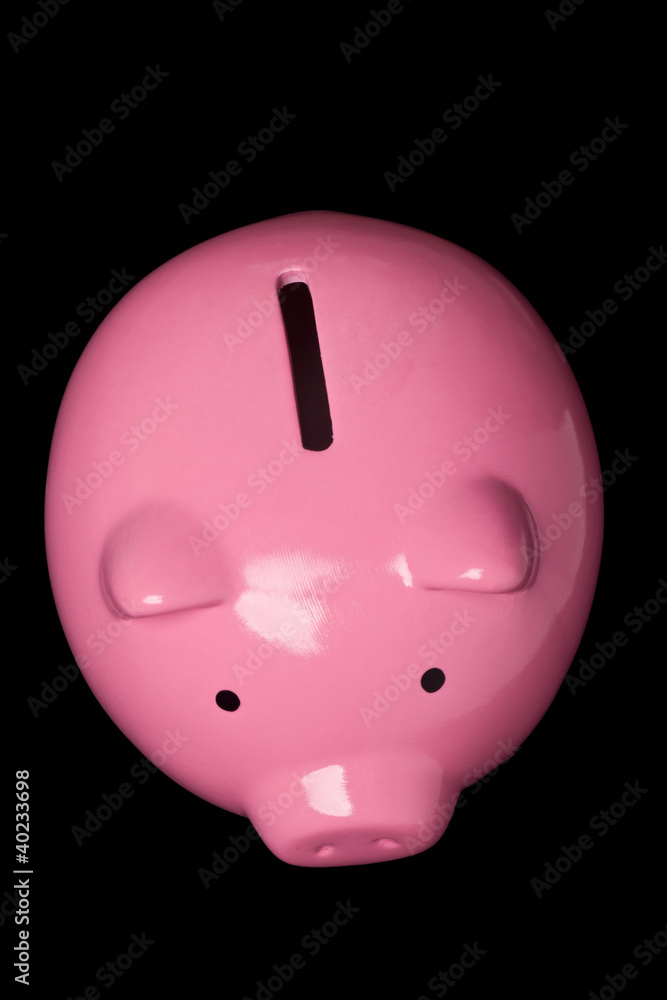Top view of a pink piggy bank isolated on black Top view of a pink piggy bank isolated on black