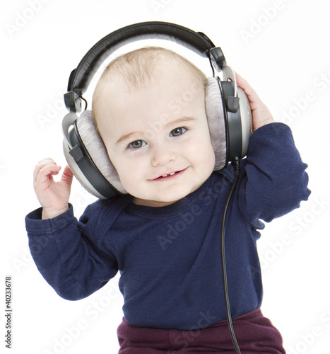 young child with ear-phones listening to music