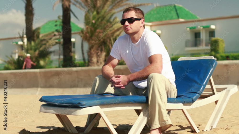 Happy young man relaxing on the beach Happy young man relaxing on the beach