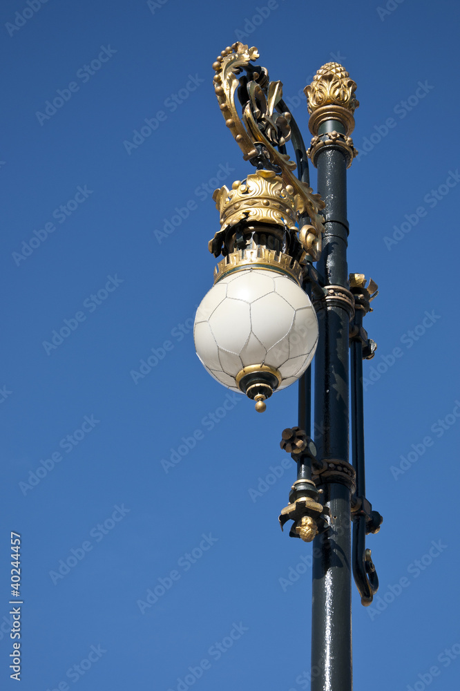 Old street lamp next to the Royal Palace of Madrid, Spain Old street lamp next to the Royal Palace of Madrid, Spain