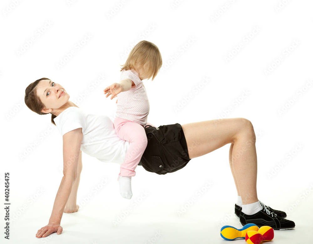 Young woman and her daughter doing sport exercises Young woman and her daughter doing sport exercises