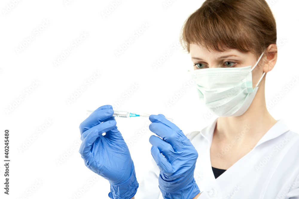 Nurse preparing syringe for injection Nurse preparing syringe for injection