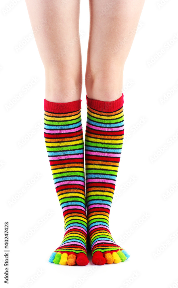 female legs in colorful striped socks isolated on white female legs in colorful striped socks isolated on white