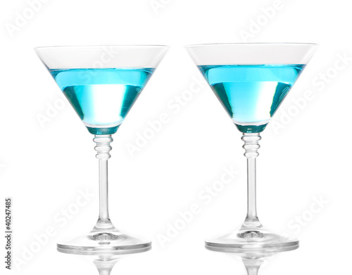 Blue cocktail in martini glasses isolated on white