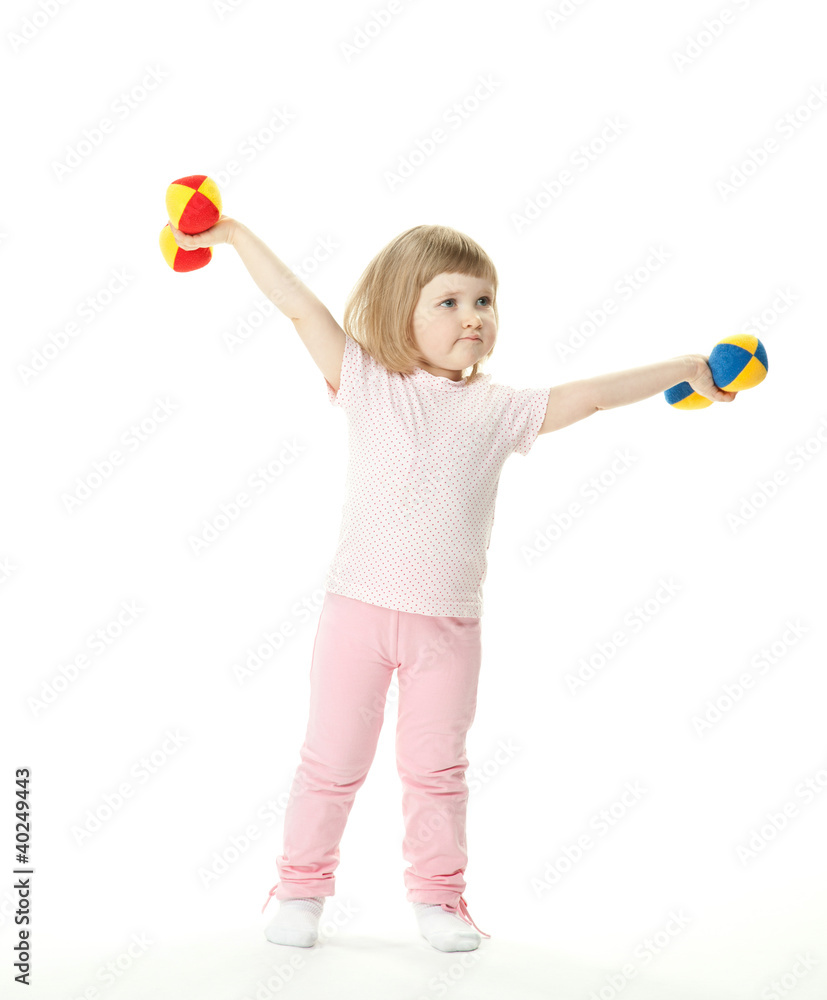 Funny little baby girl doing sport exercises with toy dumbbells Funny little baby girl doing sport exercises with toy dumbbells