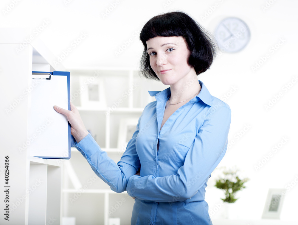 woman puts a tablet with documents in a Shelfs woman puts a tablet with documents in a Shelfs
