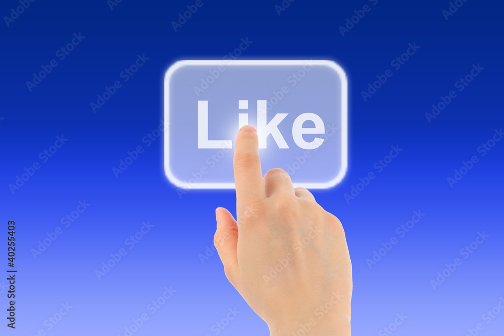 Woman hand uses like button on blue background Woman hand uses like button on blue background