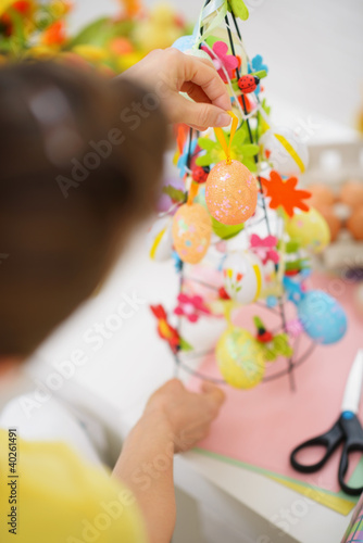 Closeup on female hands making Easter decoration
