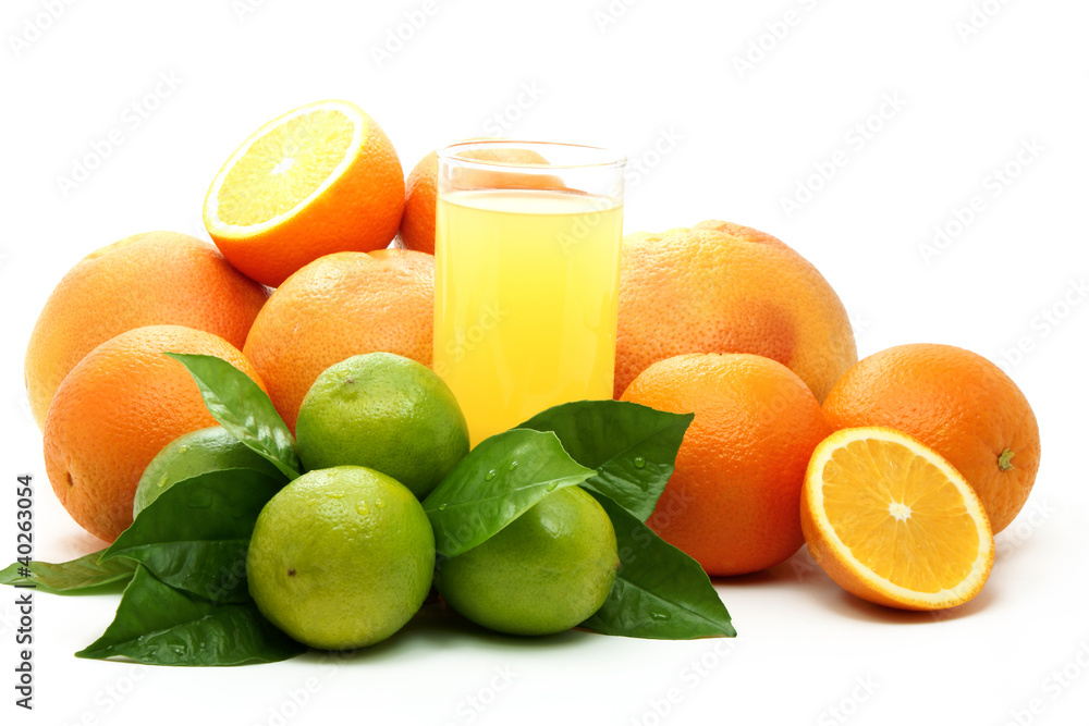 Ripe oranges , green lime and juice. Ripe oranges , green lime and juice.