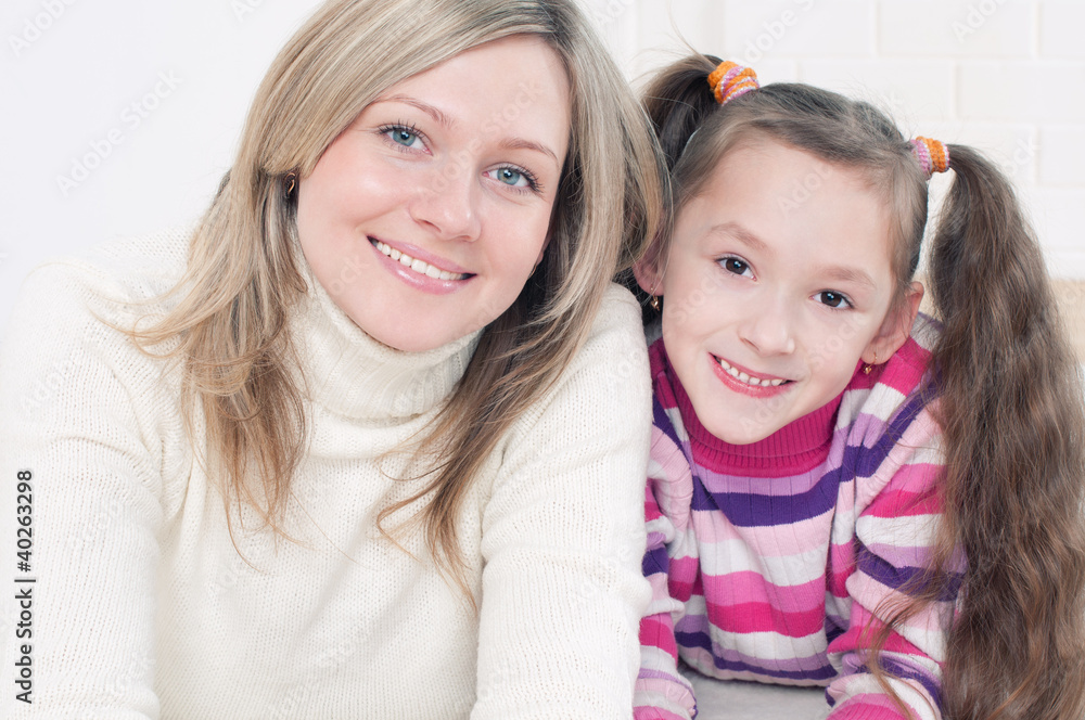 Pretty mother and her cute little daughter smiling Pretty mother and her cute little daughter smiling