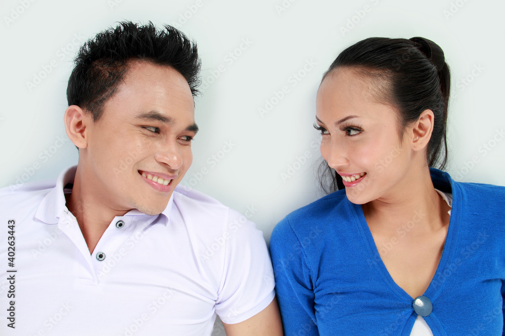 young happy couple looking each other smiling young happy couple looking each other smiling