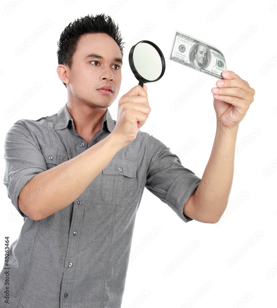 man looking dollar bill through a magnifying glass man looking dollar bill through a magnifying glass