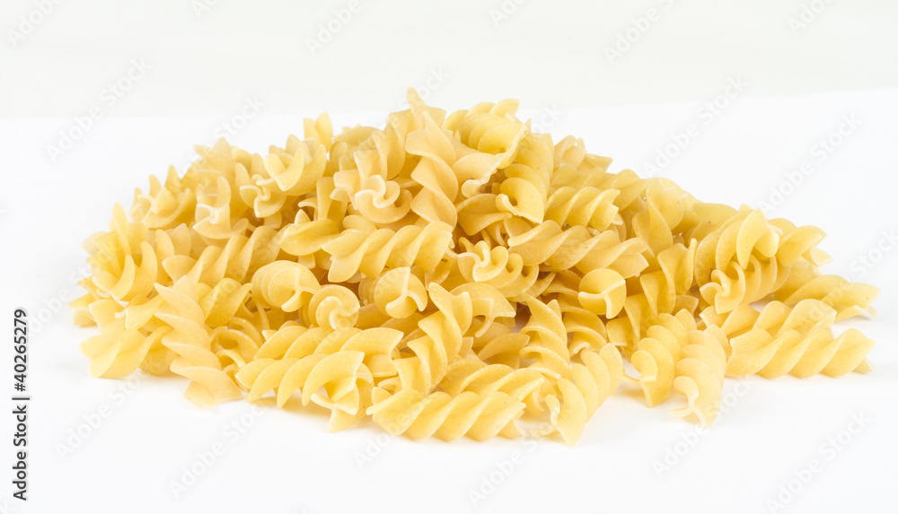 A portion of Rotini corkscrew pasta isolated on white. A portion of Rotini corkscrew pasta isolated on white.