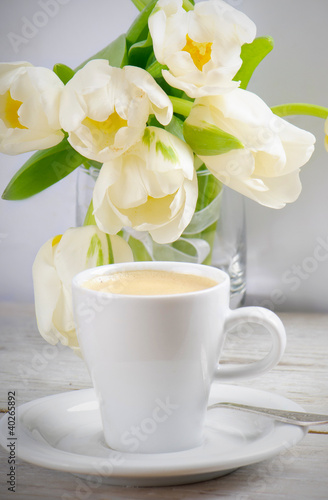 Coffee cup and white tulips © bit24