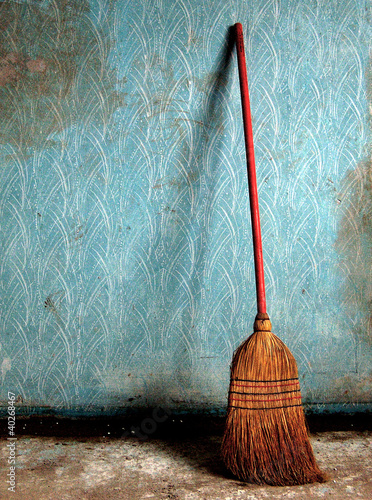 Broom on a blue wall