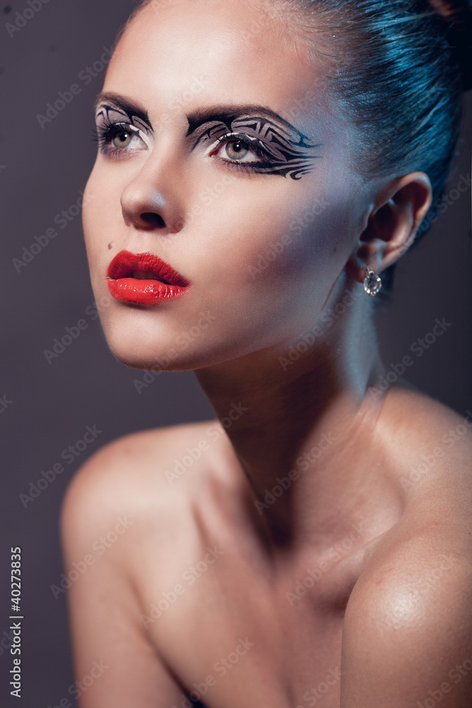 Face of a beautiful woman with creative makeup and red lips Face of a beautiful woman with creative makeup and red lips