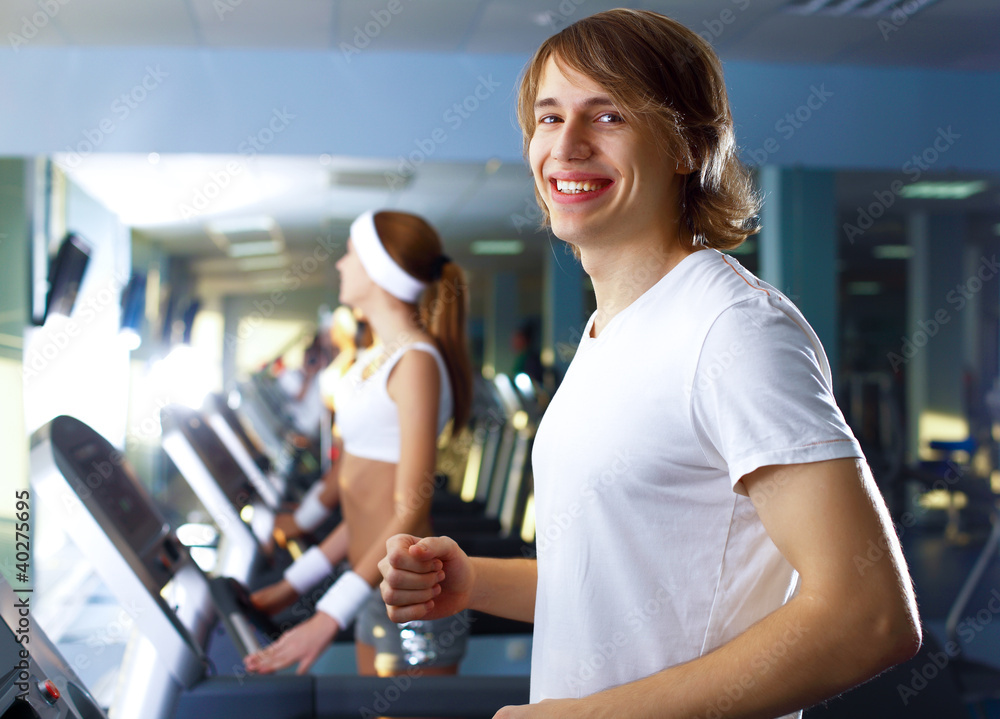 Fototapeta premium Young man doing sport in gym
