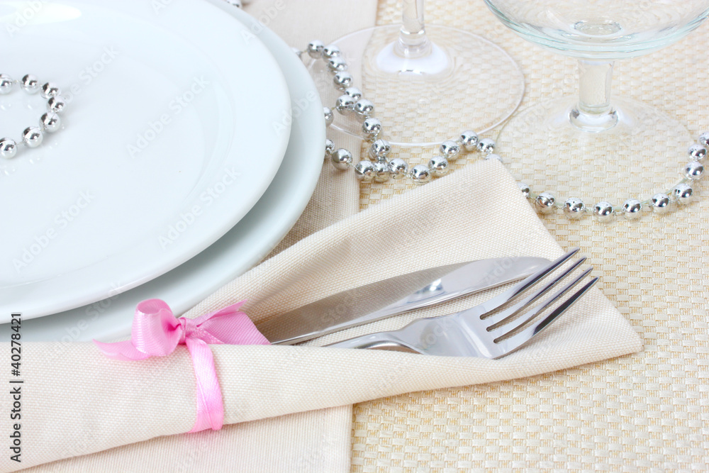 Table setting with fork, knife, plates, and napkin Table setting with fork, knife, plates, and napkin