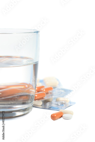 Tablets and a glass of water