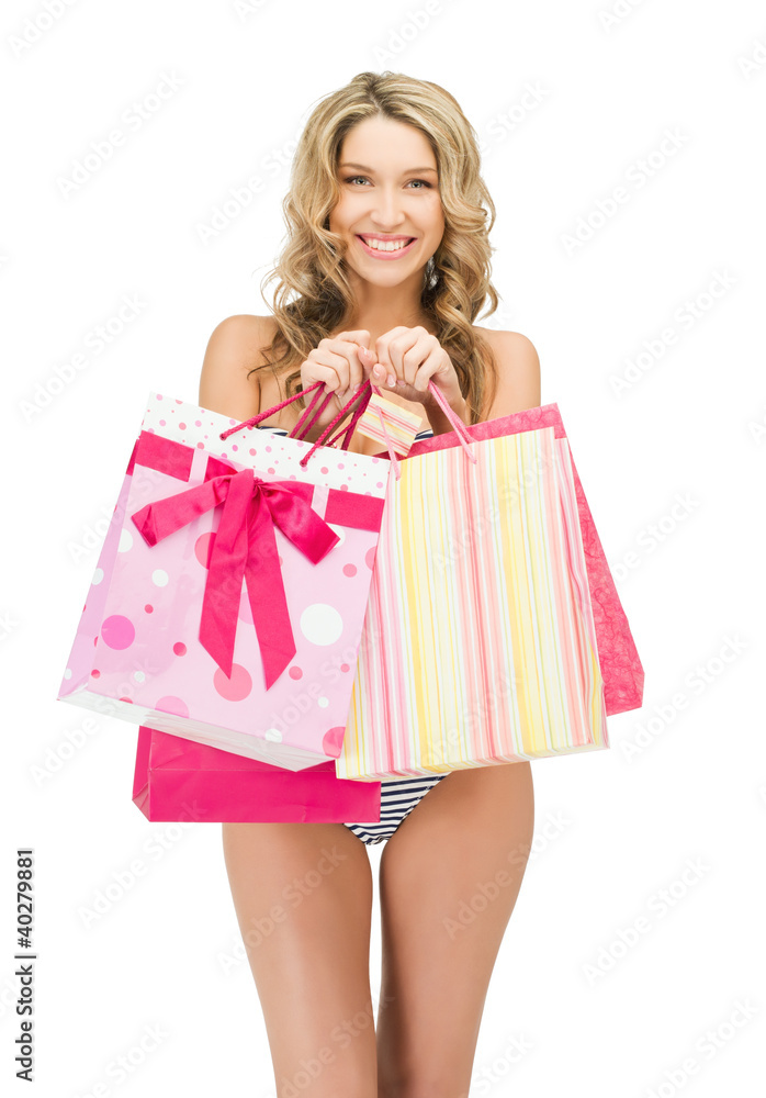 seductive woman in bikini with shopping bags