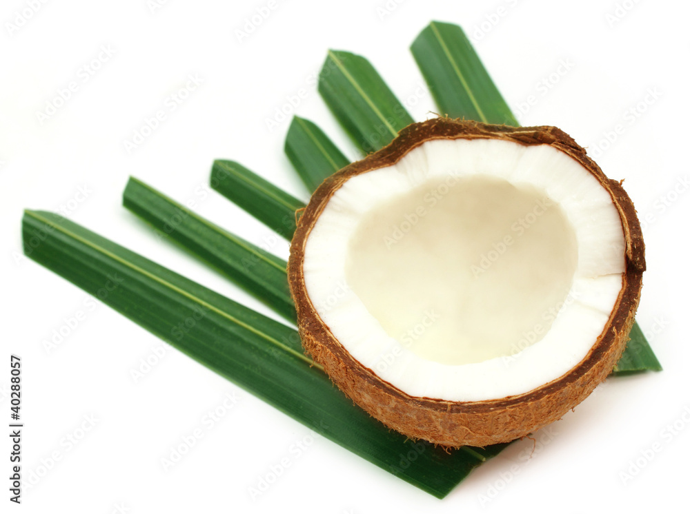 Fresh Coconut with green leaves over white background Fresh Coconut with green leaves over white background