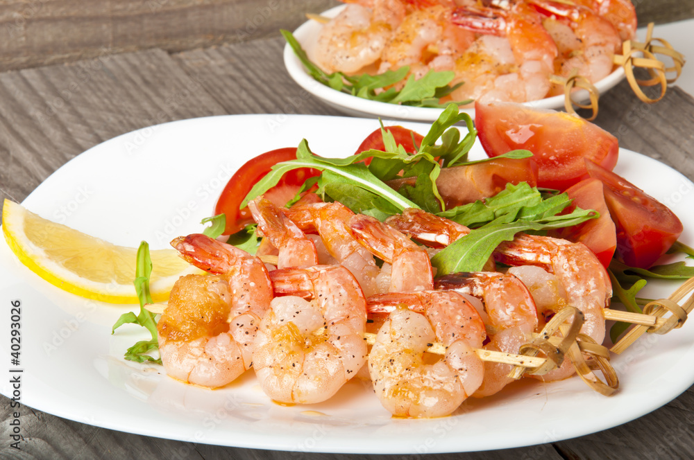 Fresh grilled shrimps with lemon on white plate Fresh grilled shrimps with lemon on white plate