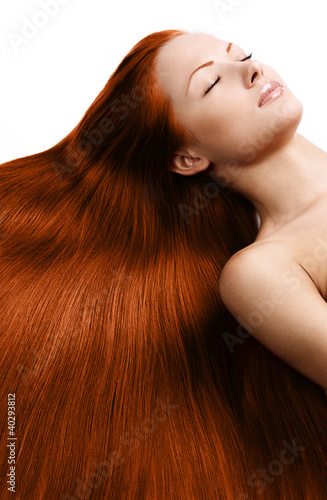 young woman with long healthy shiny red hair