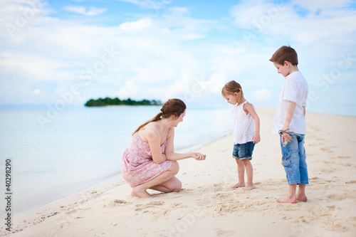 Mother and two kids on beach