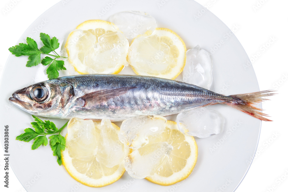 Mackerel in a dish with lemon and parsley. On a white background Mackerel in a dish with lemon and parsley. On a white background